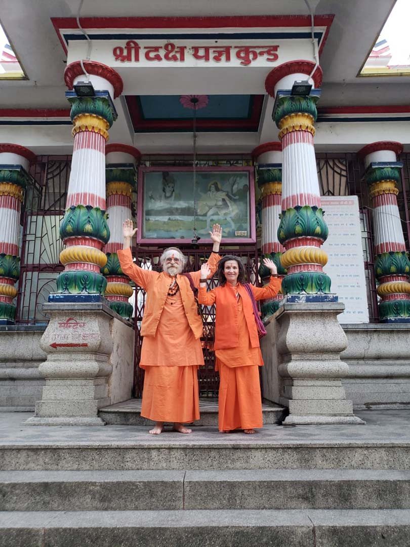 Goa Gil and Ariane doing celebration pose in front of Shiva temple entrance